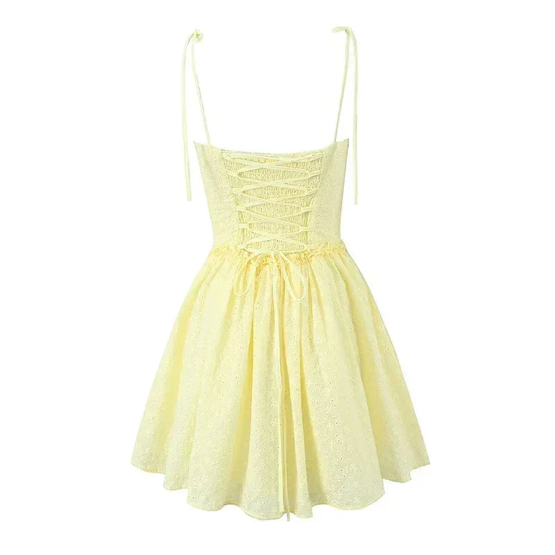 YENKYE Sexy Elegant Women Hollow Out Embroidery Yellow Sling Mini Dress Low Waist Lace Up Bandage Party Dresses Birthday Robe